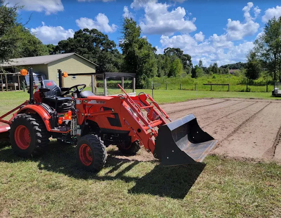 Compact tractor with front loader on a freshly worked property in Dunnellon FL
